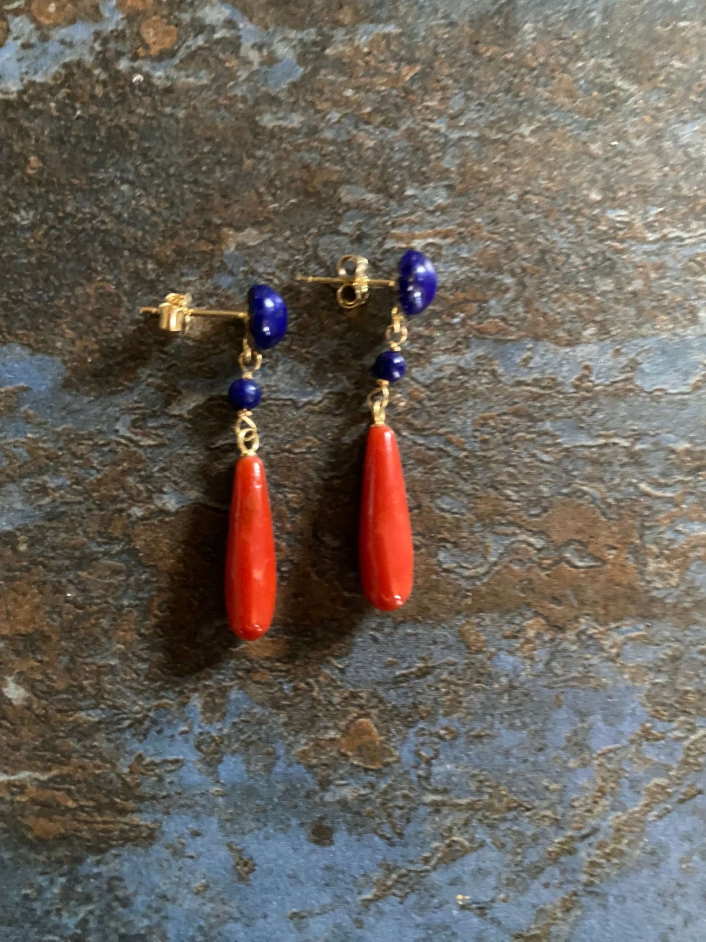 golden earrings with a coral drop and lapis beads