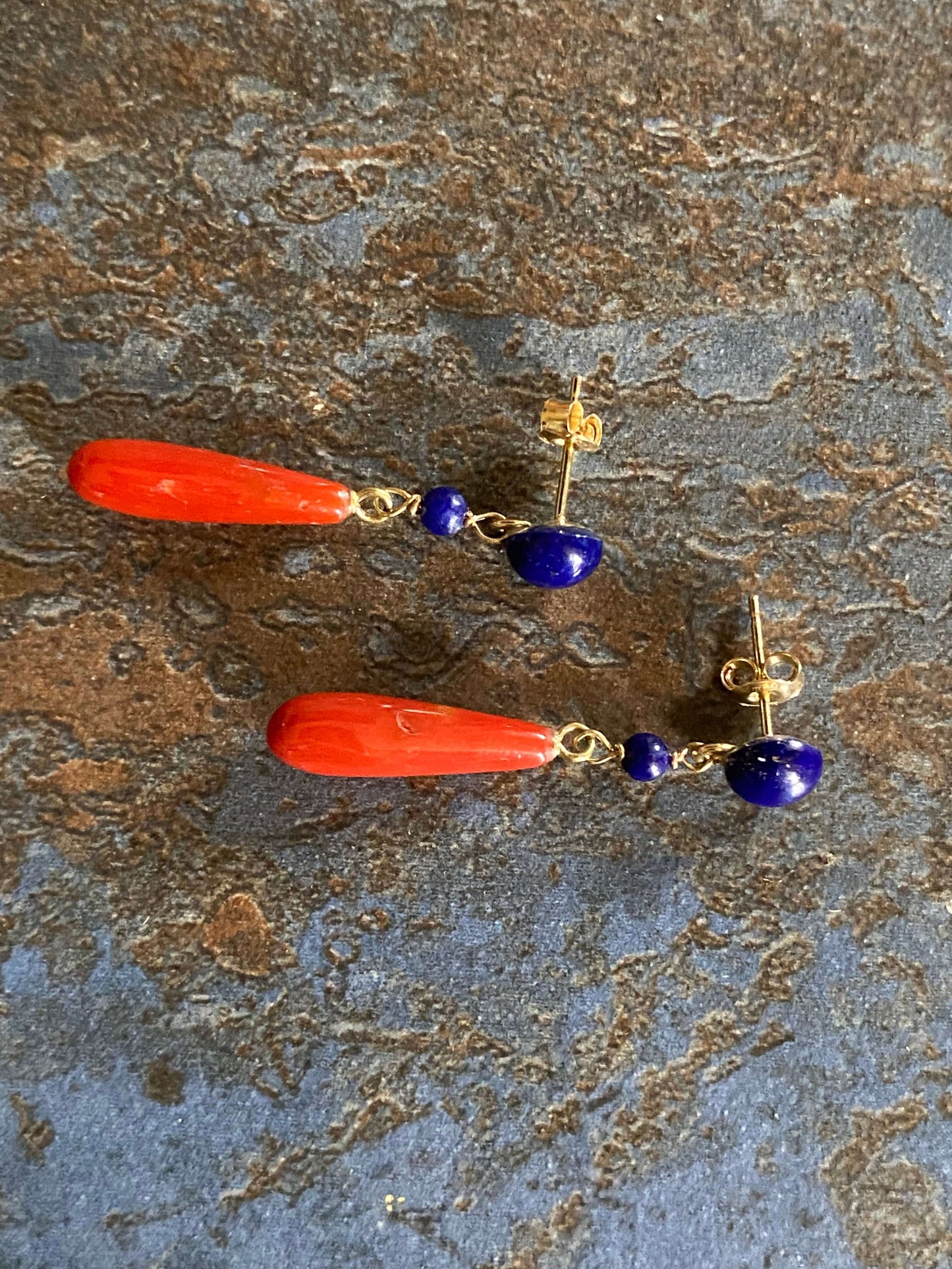 golden earrings with a coral drop and lapis beads