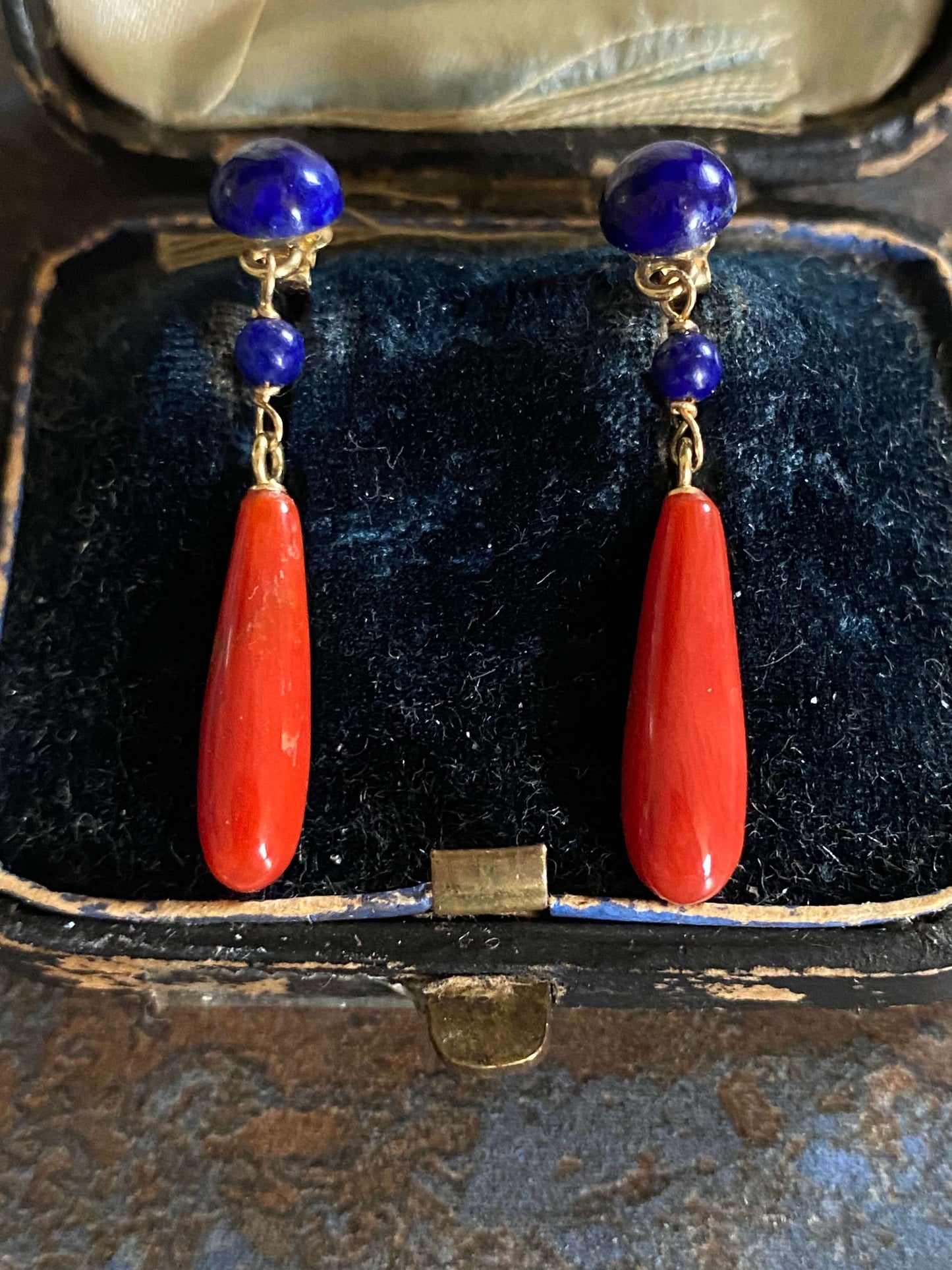 golden earrings with a coral drop and lapis beads