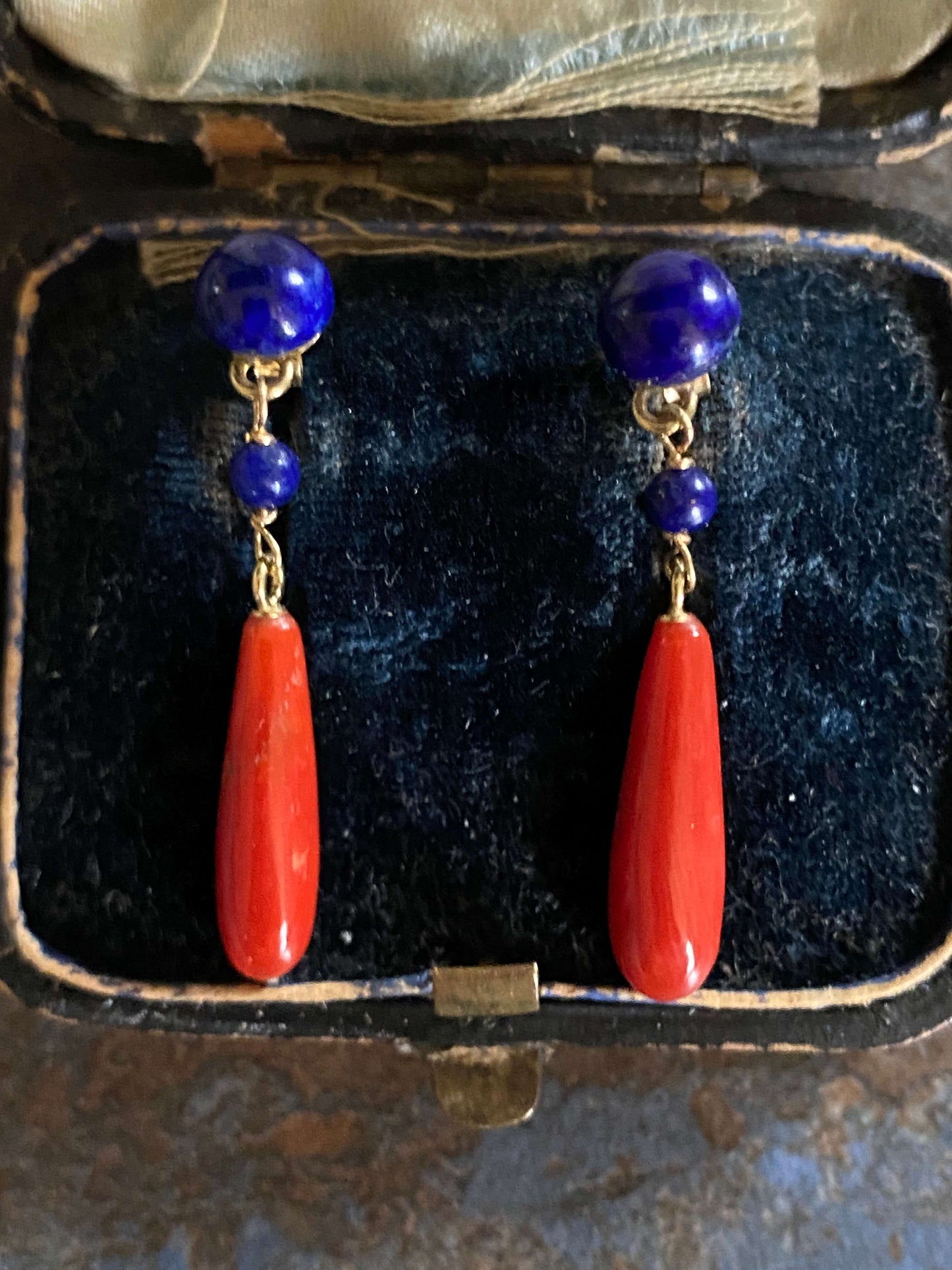 golden earrings with a coral drop and lapis beads