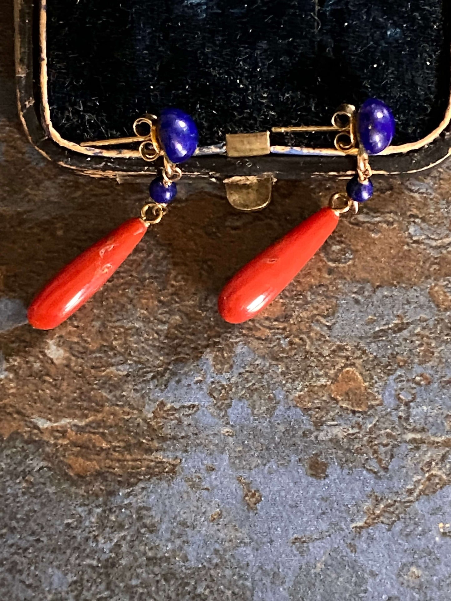 golden earrings with a coral drop and lapis beads
